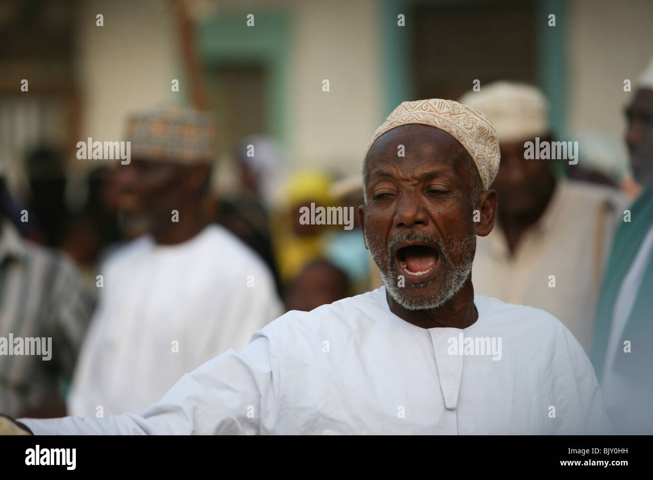 A man during the maulidi celebration of Prophet Mohammed's birthday outside Riyadha Mosque Lamu Kenya Stock Photo