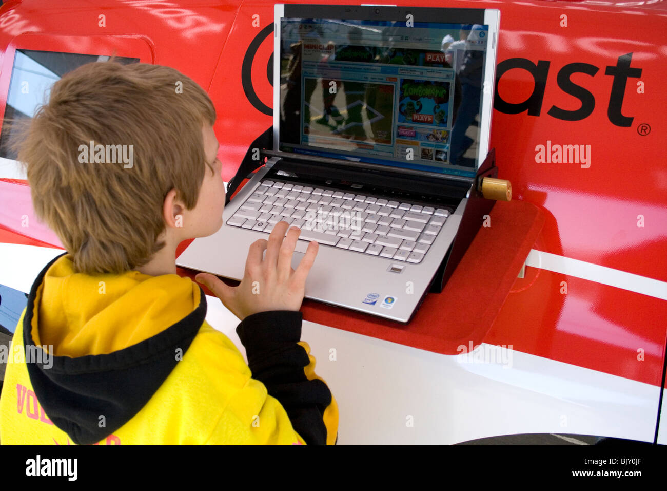 Boy age 7 trying laptop computer at vendors booth. Cinco de Mayo Fiesta St Paul Minnesota USA Stock Photo