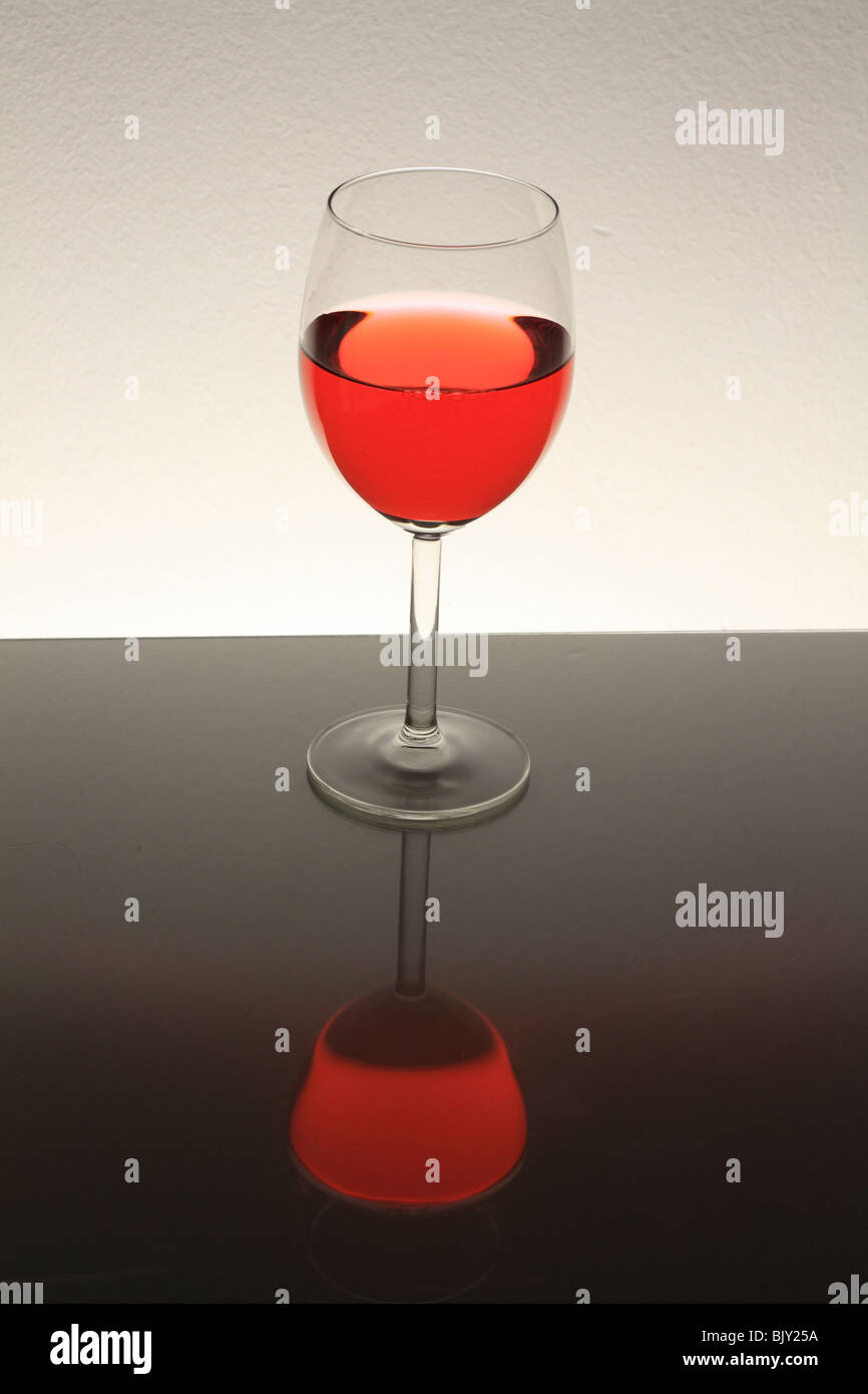 wine glass with red wine  on table with reflection Stock Photo