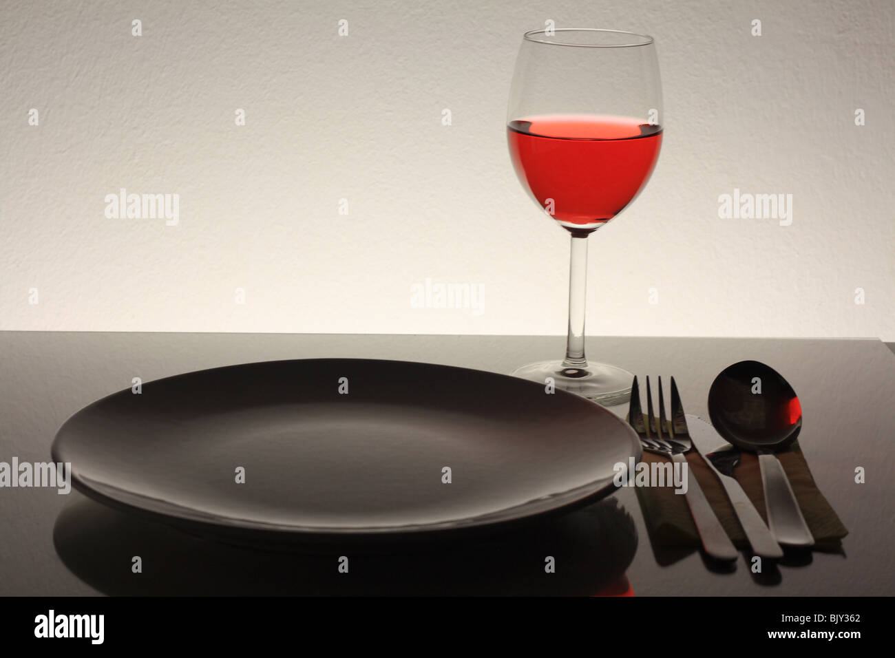 wine glass, fork knife, plate and spoon Stock Photo