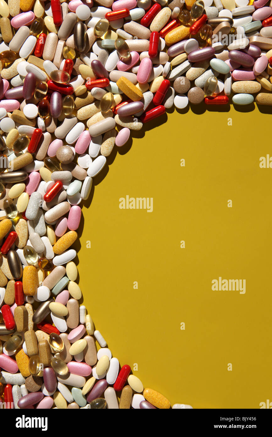 An blank space for a oval plate with a background of colorful capsules, tablets and pills Stock Photo