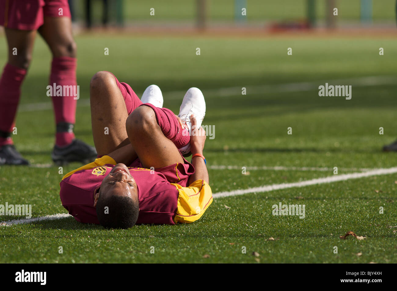 footballer writhes in agony after being injured Stock Photo - Alamy