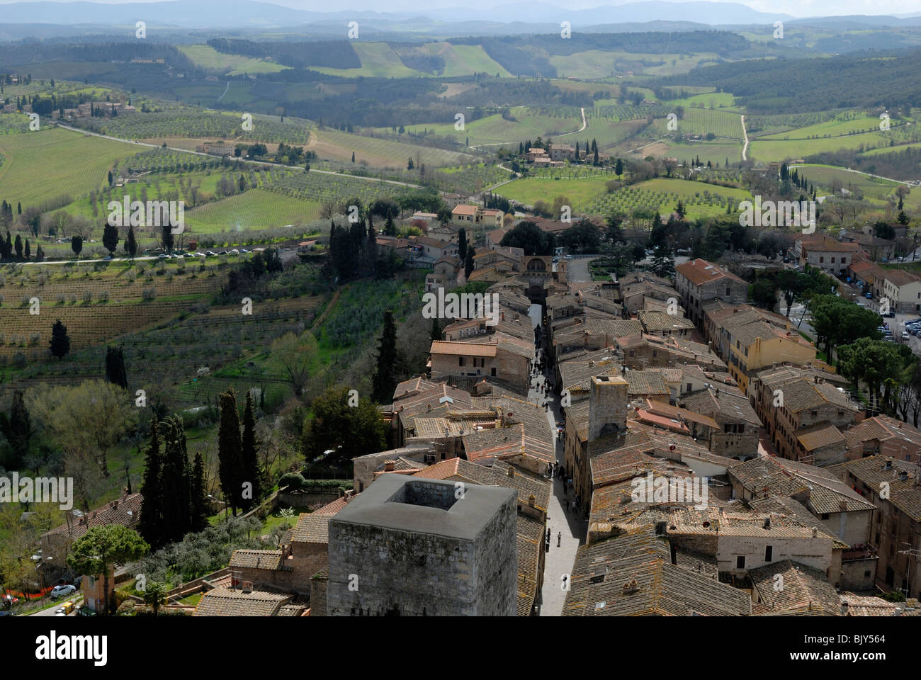 A spectacular view to the south of the roof tops of the Via San Giovanni and the surrounding countryside from the Torre Grossa. Stock Photo