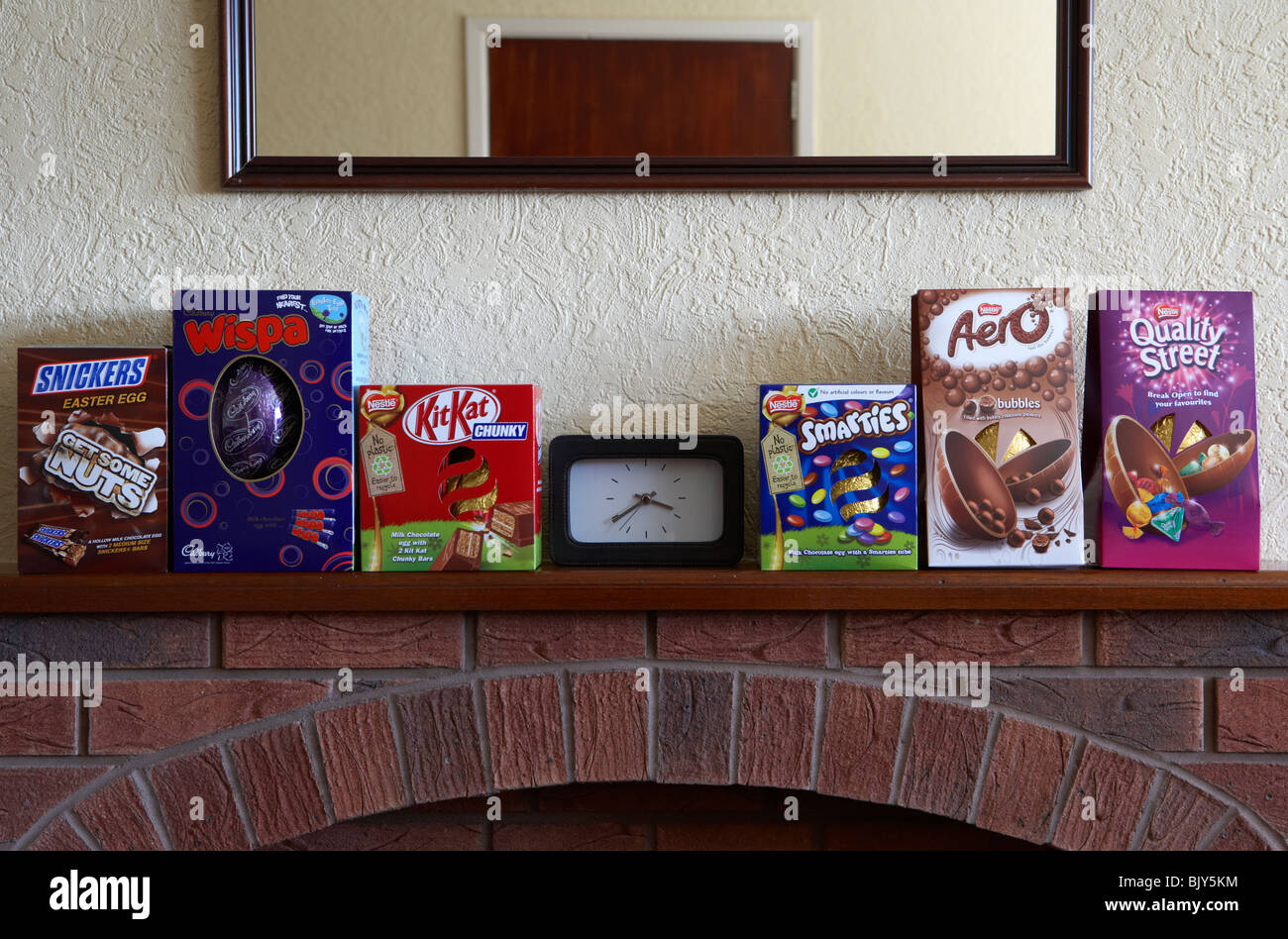 Easter eggs sitting on a fireplace mantlepiece in a living room in the uk Stock Photo