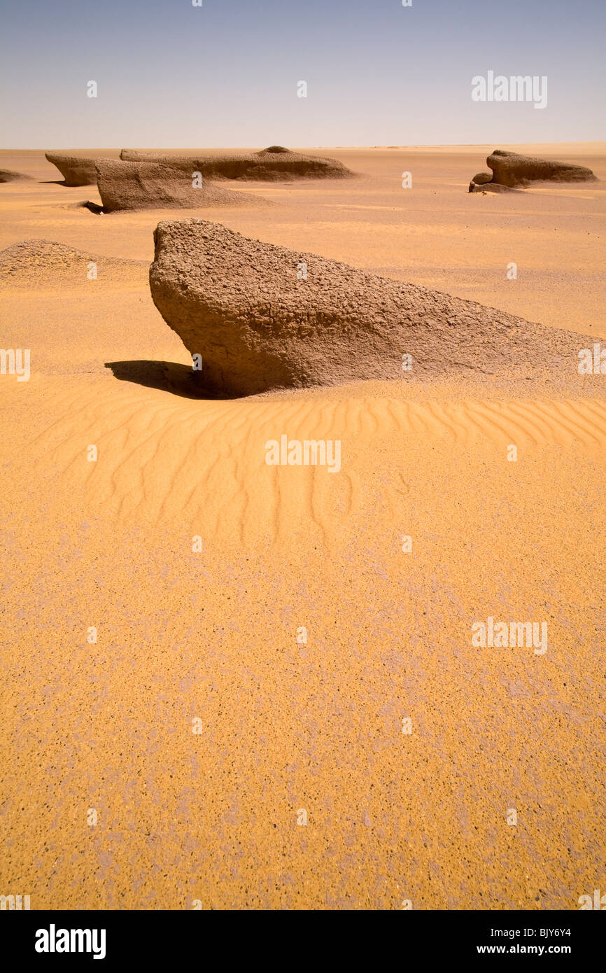 Yardangs, or mud lions, in mid day sun in Sahara Desert, en route to the Gilf Kebir, Western Desert of Egypt Stock Photo