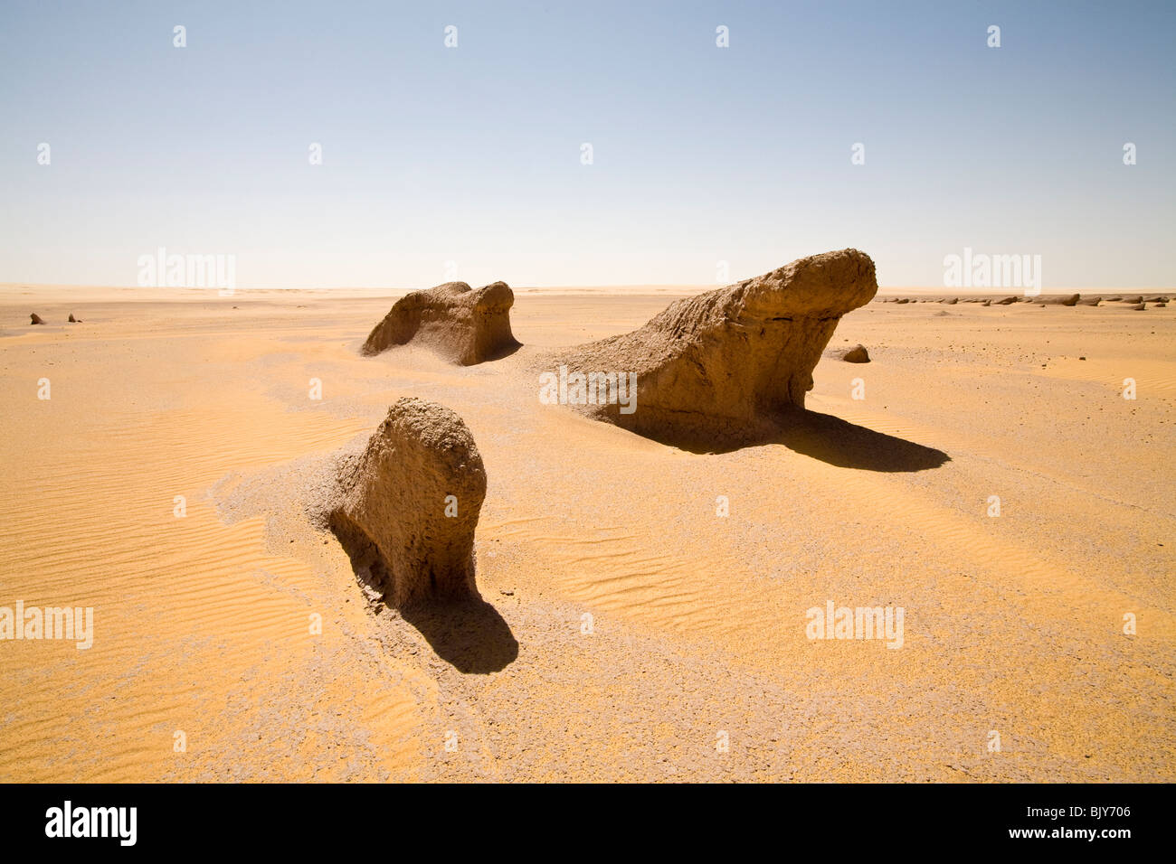 Yardangs, or mud lions, in mid day sun in Sahara Desert, en route to the Gilf Kebir, Western Desert of Egypt Stock Photo