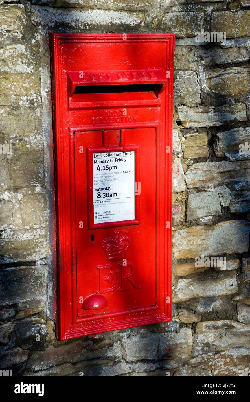 Old red postbox built into a wall. Stock Photo