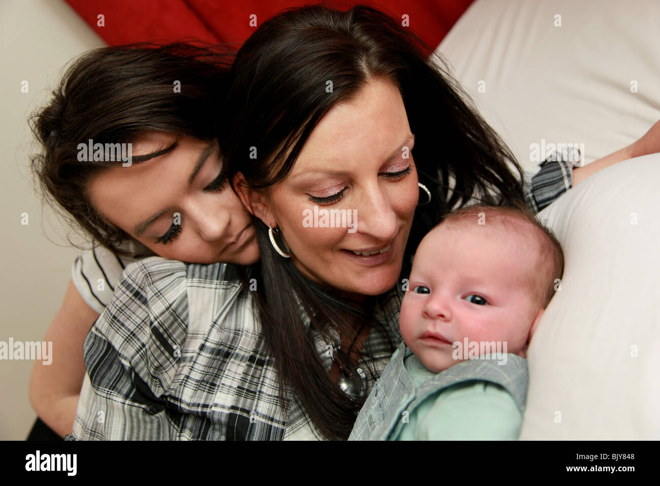 Mum, teenage daughter and 5 week old baby boy Stock Photo