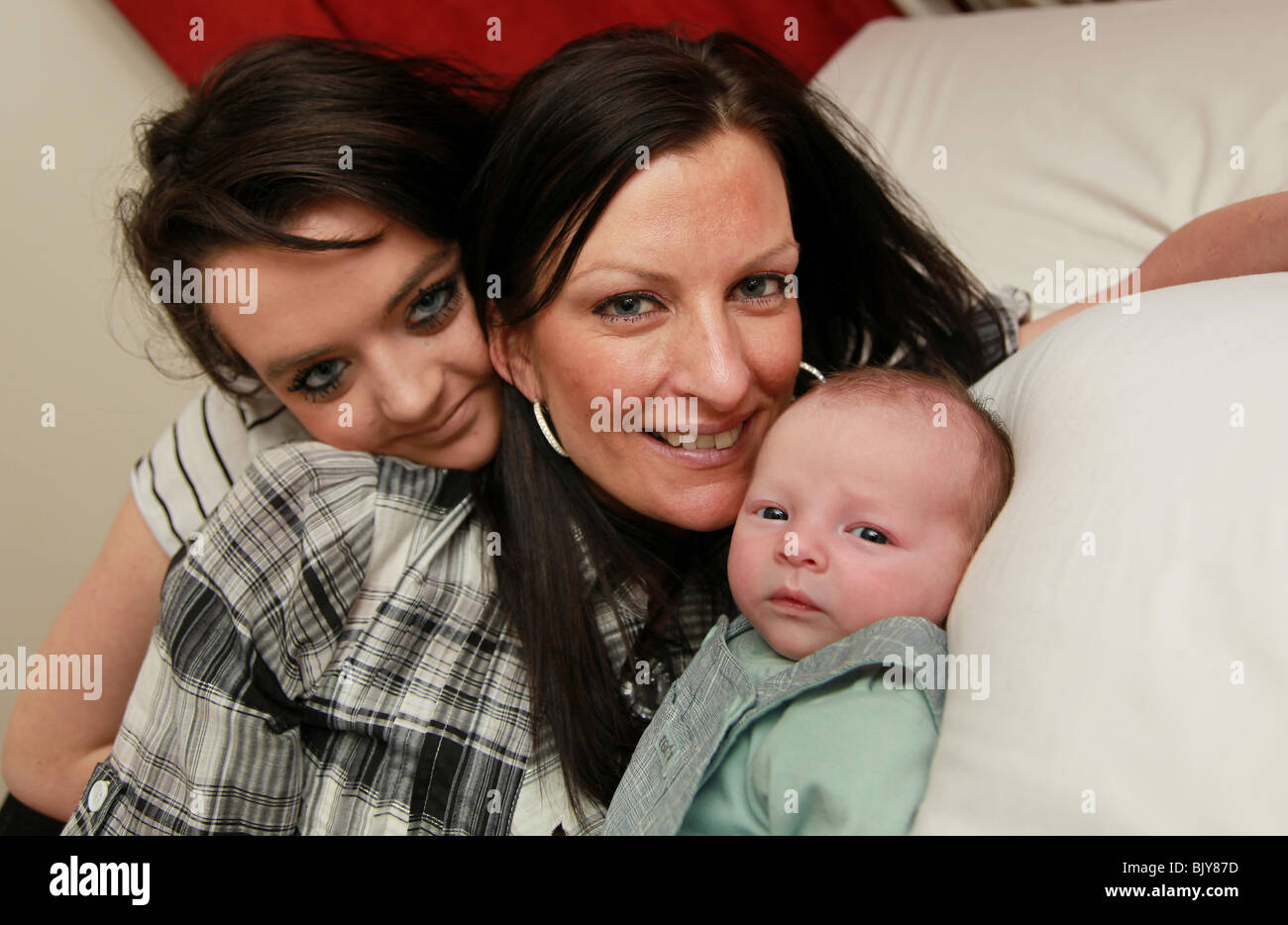 Mum, teenage daughter and 5 week old baby boy Stock Photo