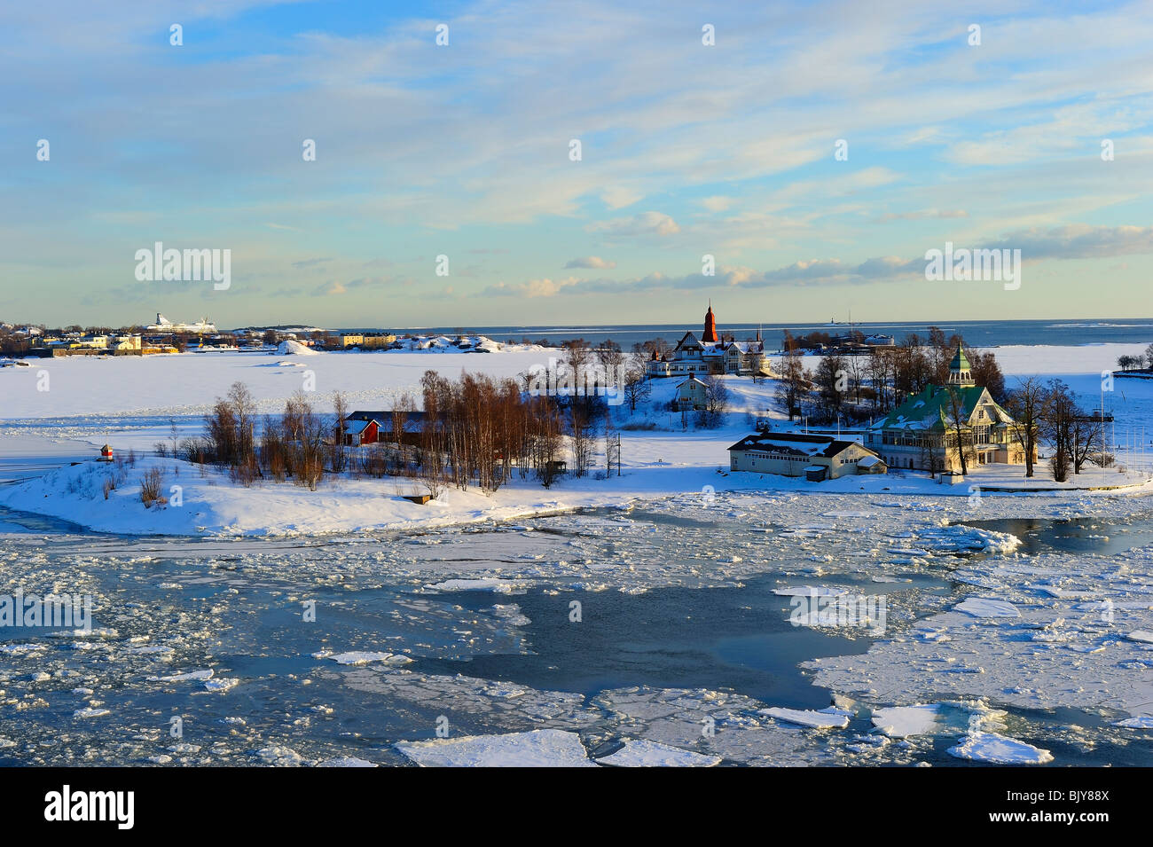 Icy Baltic sea at Katajanokka Helsinki, with Finnish houses on Valkosaari and Luoto islands Stock Photo