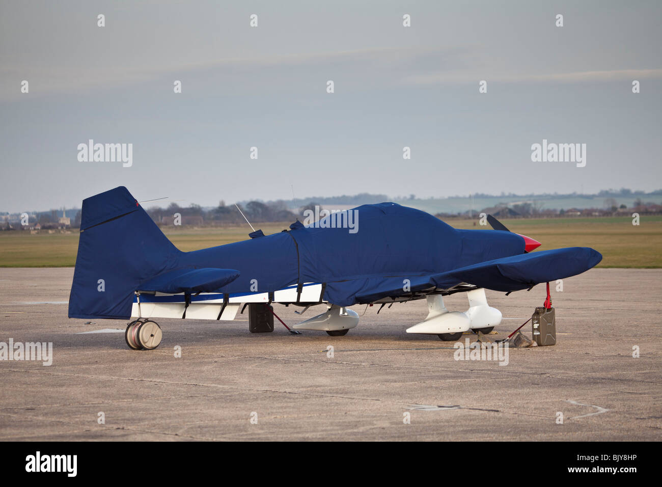 Light aircraft in protective covers Stock Photo