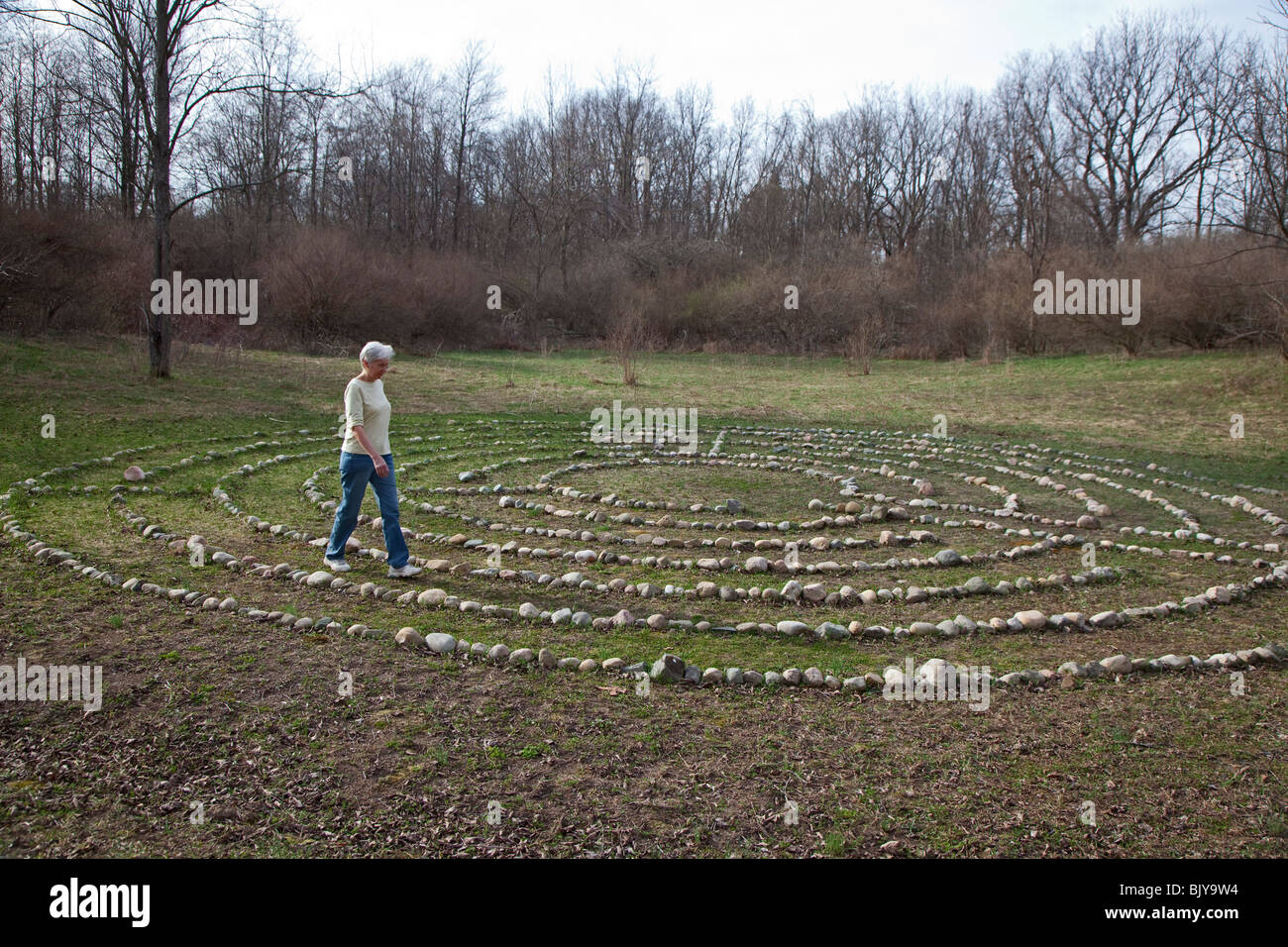 Woman Walks in Meditation Labyrinth Stock Photo