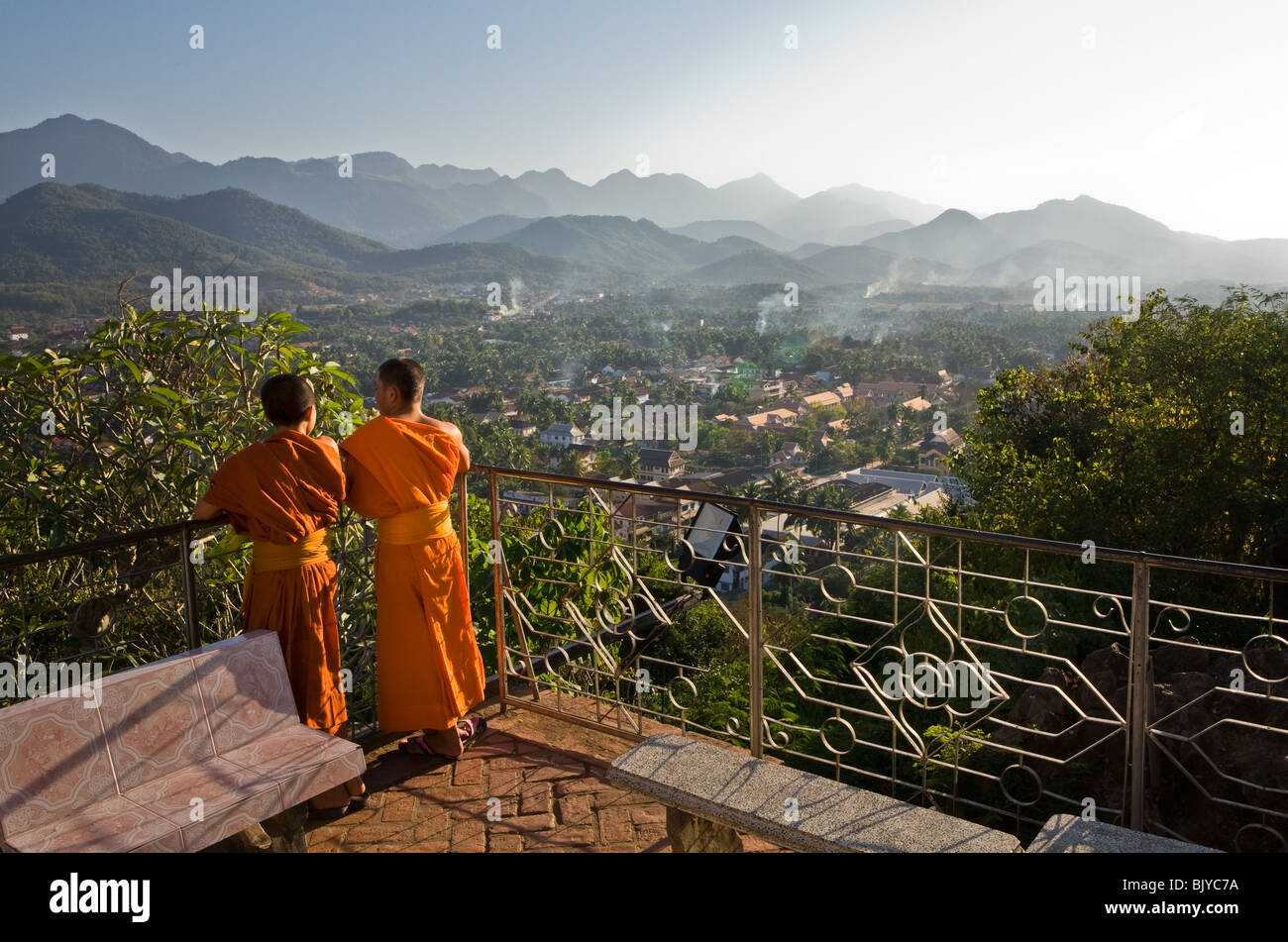 Two Buddhist monks look out over Luang Prabang. Laos, Asia. Stock Photo