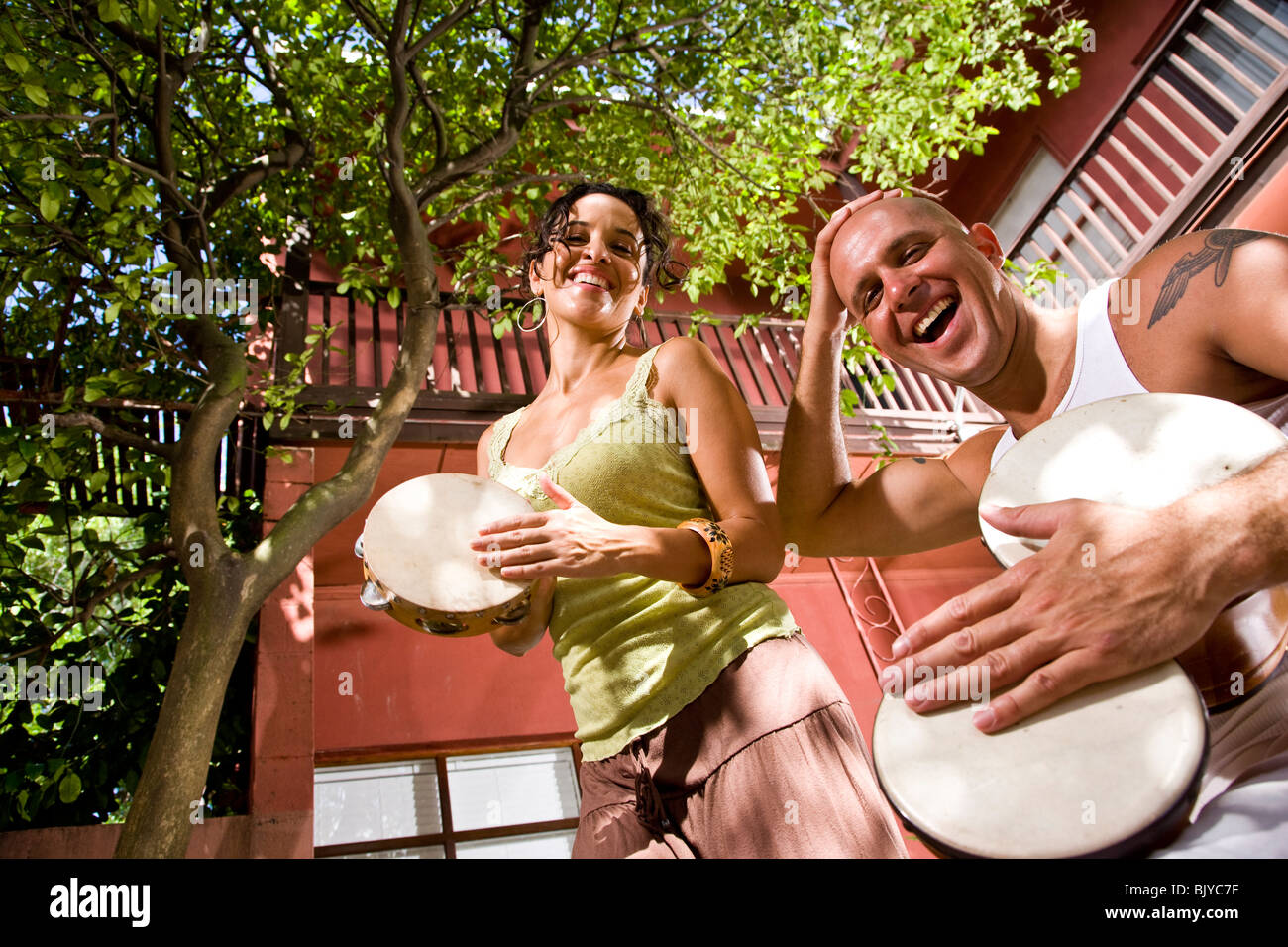 Young couple making music together outdoors Stock Photo