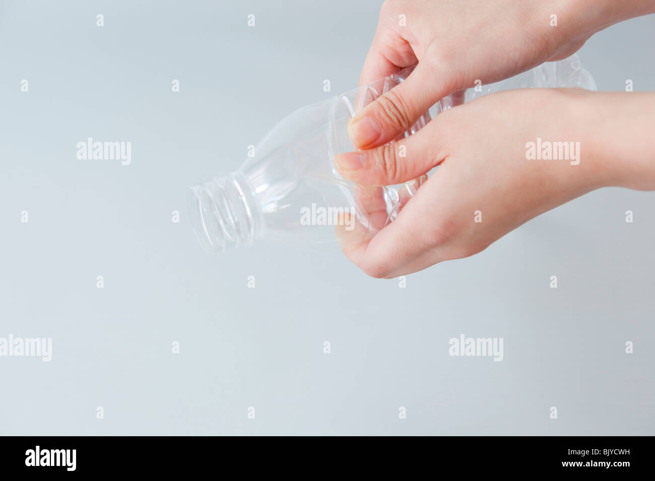 Hand of a woman crushing plastic bottle Stock Photo Alamy