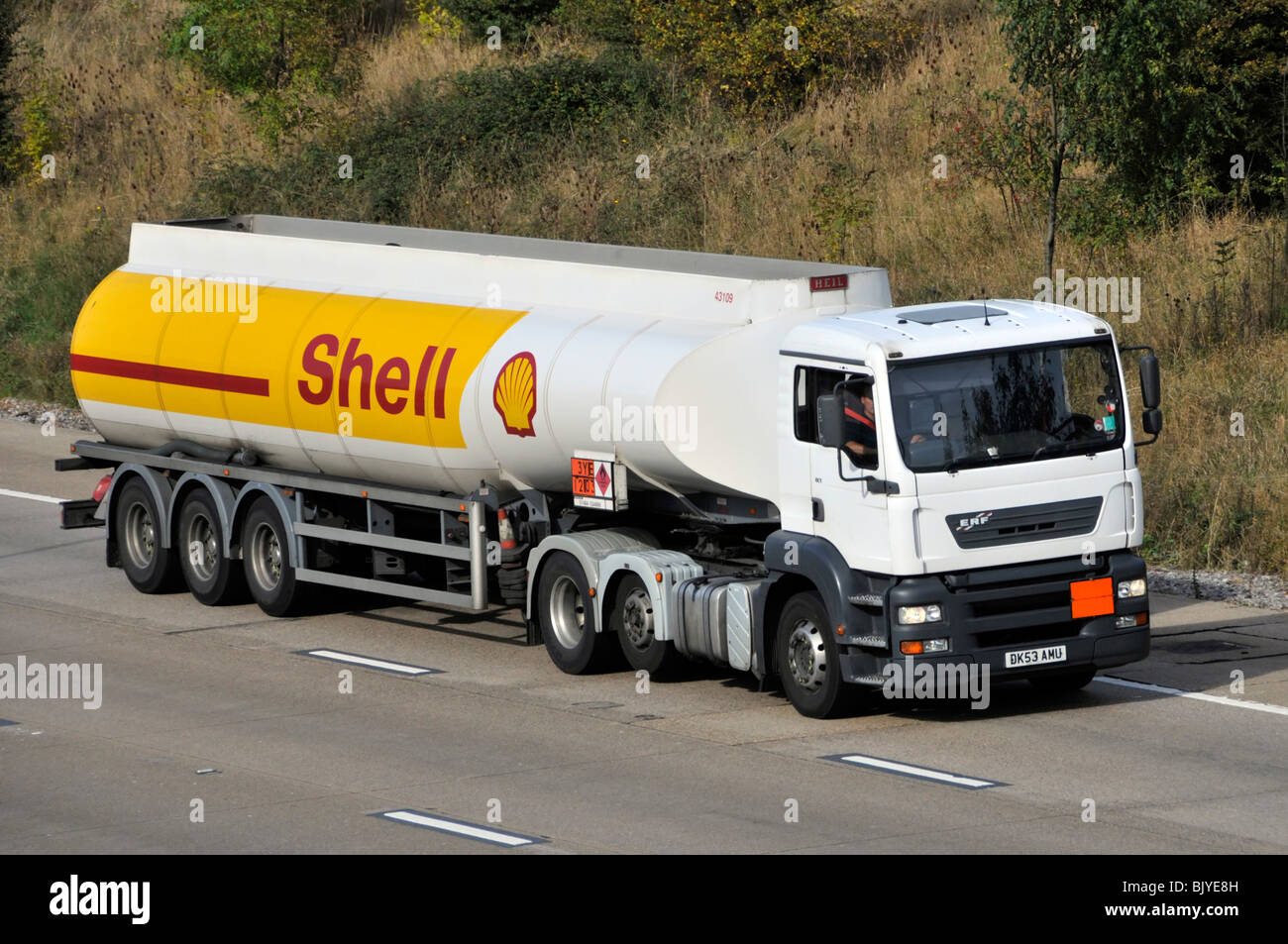 M25 motorway Shell fuel tanker ERF lorry tyre saving raised axle Hazchem Hazardous Chemicals Dangerous Goods sign Stock Photo