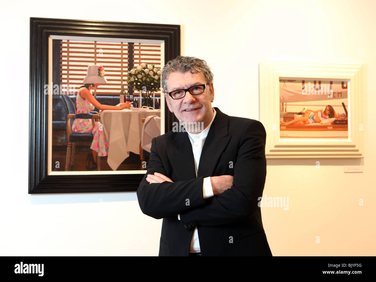 Scottish painter Jack Vettriano pictured with some of his work Stock