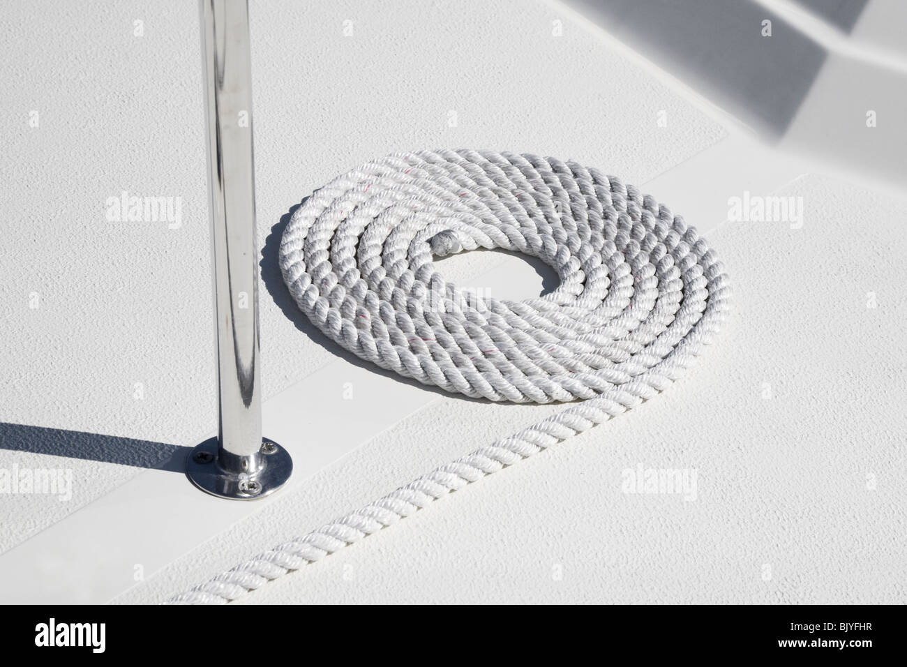 Rope in a tidy circle on the deck of a boat. Stock Photo
