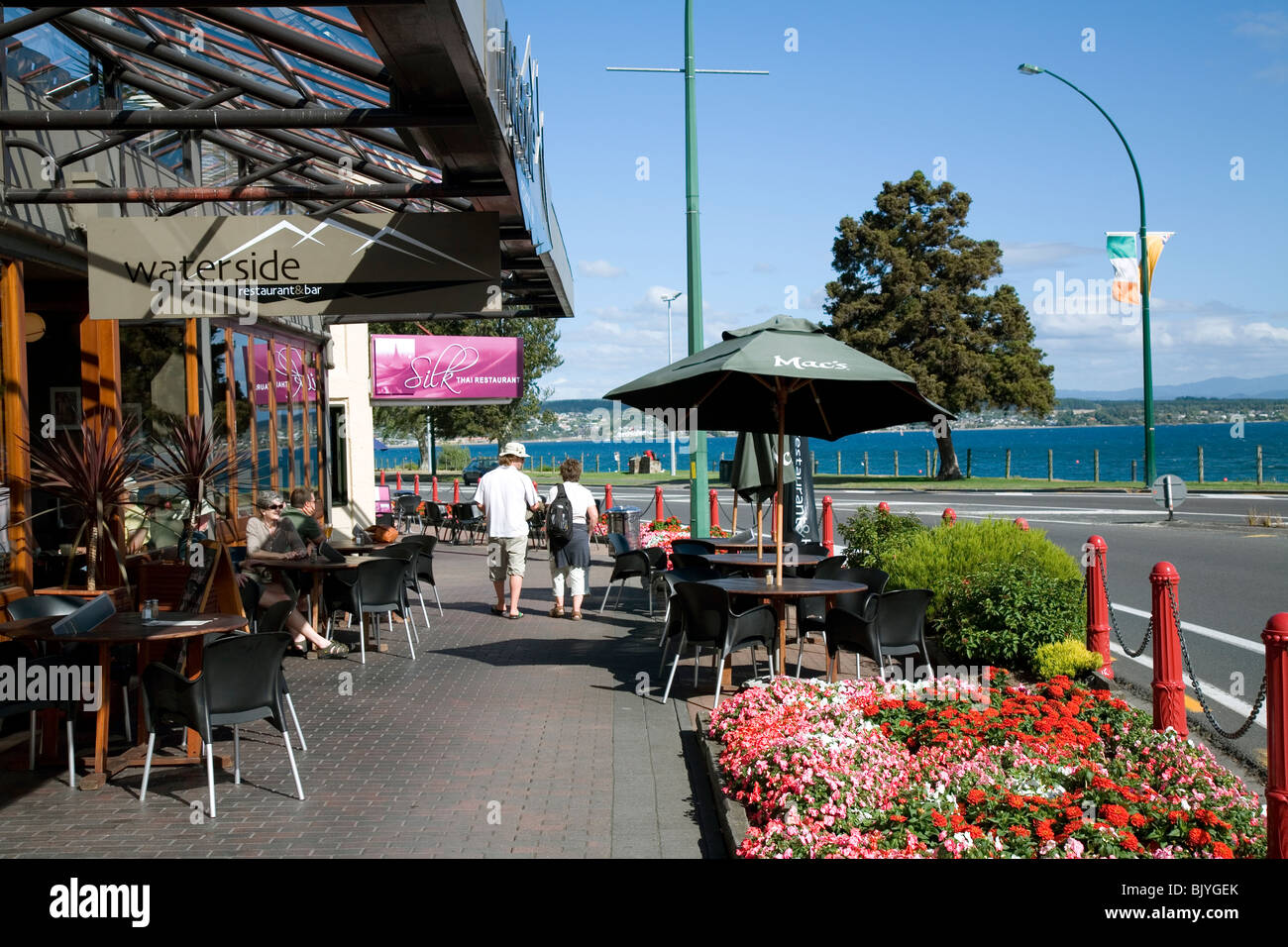 The neatly manicured and visitor friendly town of Taupo nestles on the shores of volcanically formed Lake Taupo New Zealand Stock Photo