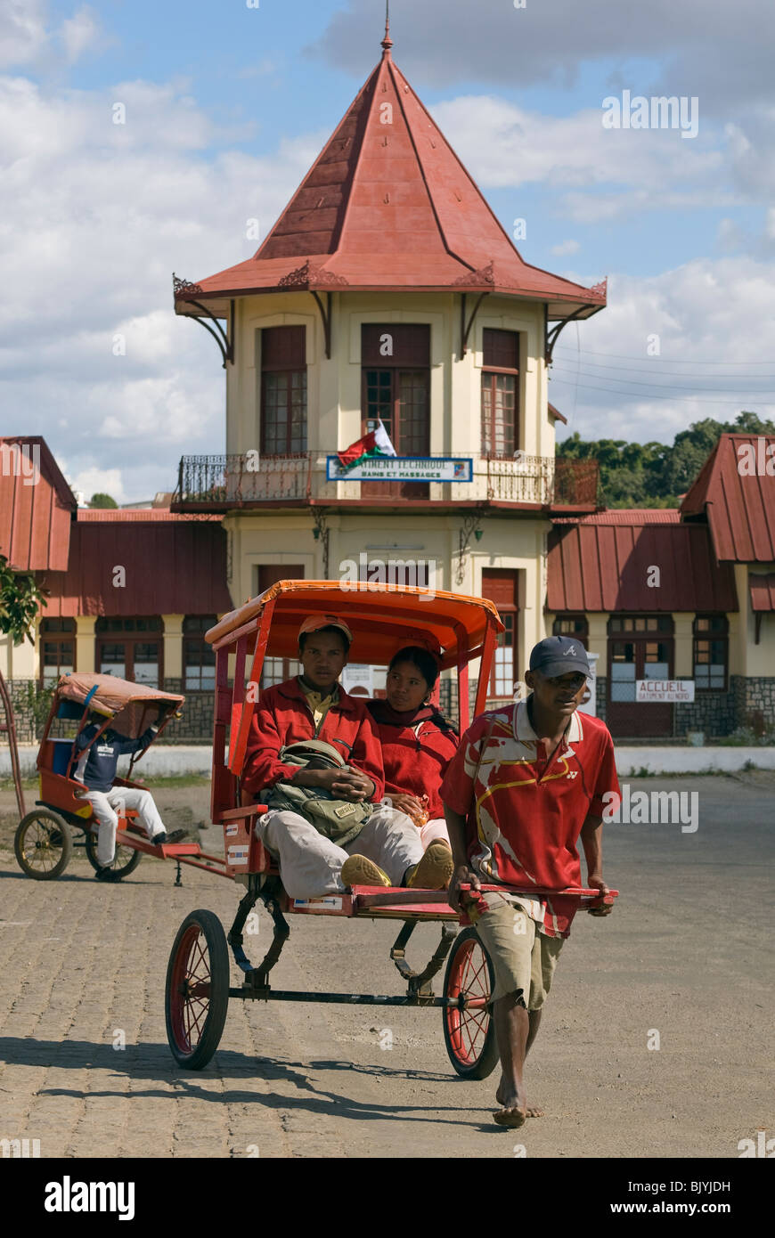 Pousse Posuse Pousse-pousse driver with passengers, Antsirabe, Madagascar Stock Photo ...