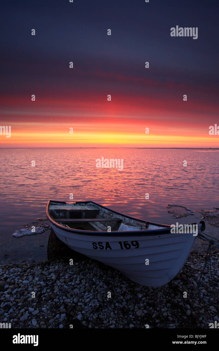 Small fishing boat by the Baltic Sea coast in Sunset. Saaremaa Island Stock Photo