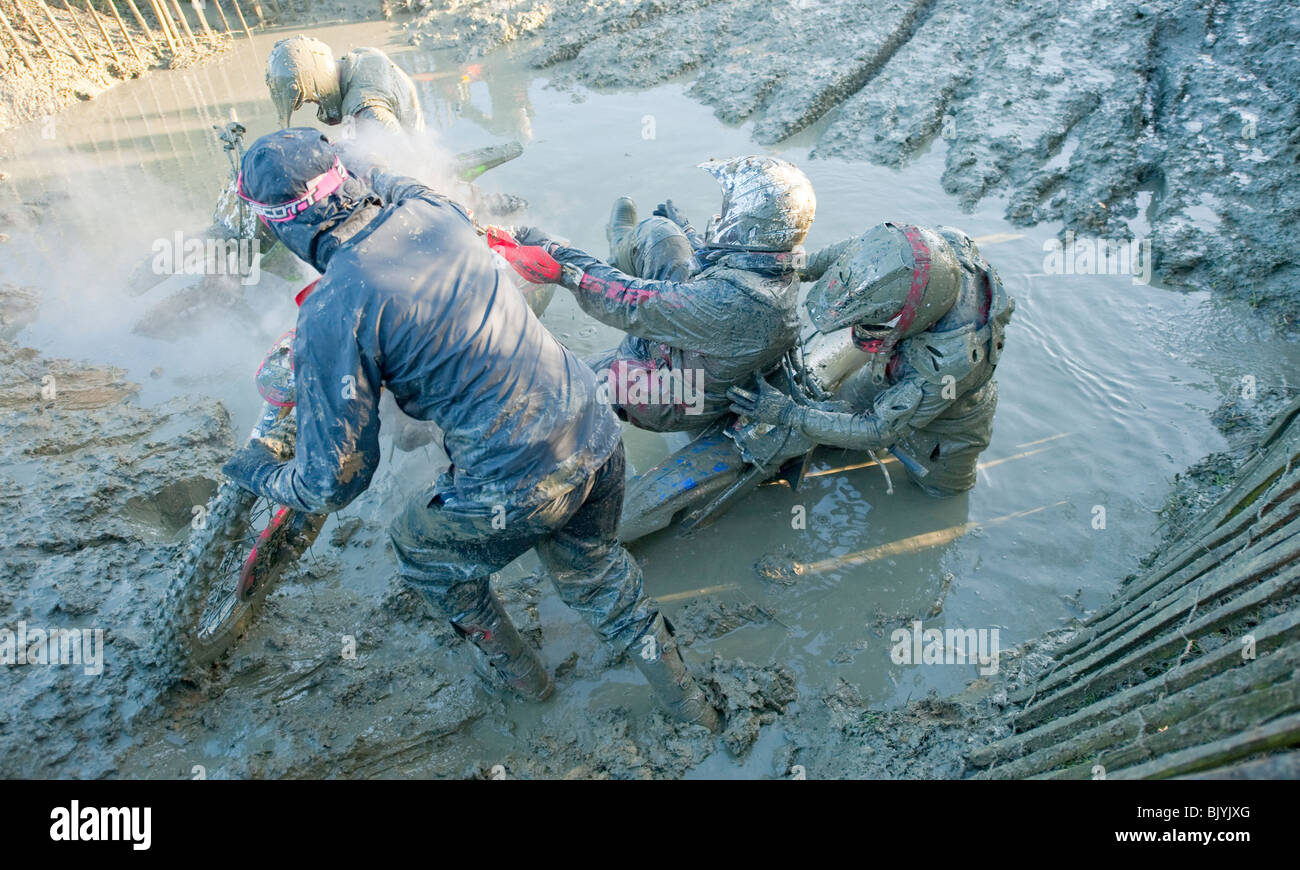 Motocross bike riders stuck in deep mud Stock Photo