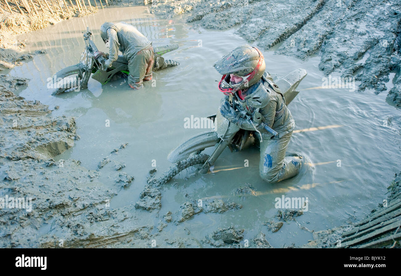 Motocross bike riders stuck in deep mud Stock Photo