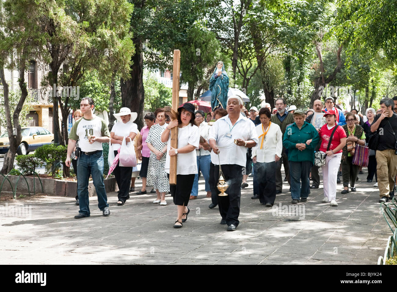 diverse group devout people performing Stations of Cross on Good Friday in Roma district of Mexico City Stock Photo