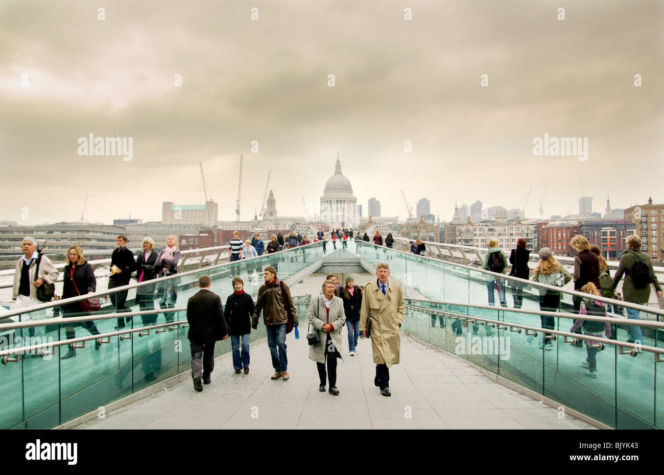 a hazy Saint Pauls cathedral and people on Millennium Bridge, London Stock Photo