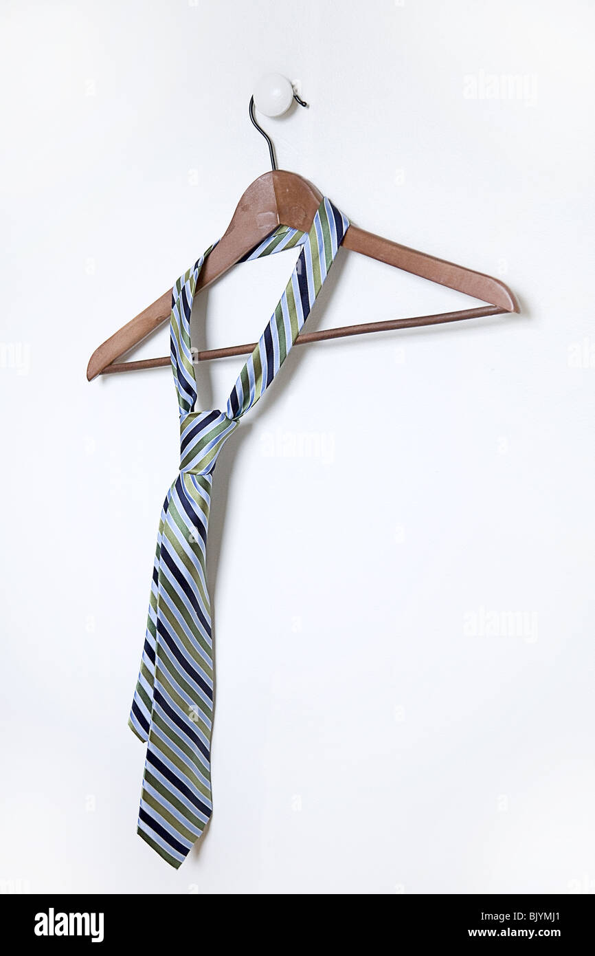 man's necktie hanging on a hanger on white handle Stock Photo Alamy