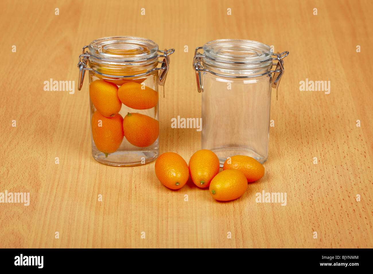 Production of exotic citrus fruits canned - two cans and kumquat Stock Photo