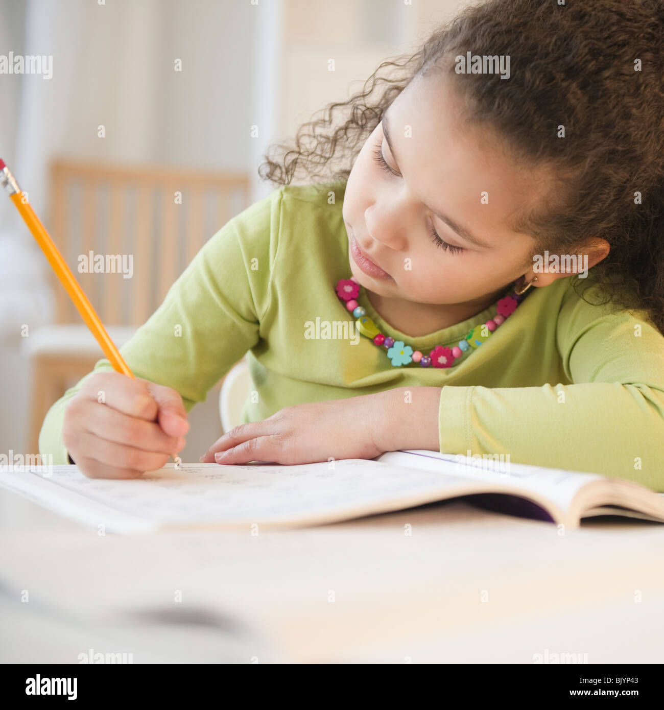 Hispanic girl doing homework Stock Photo