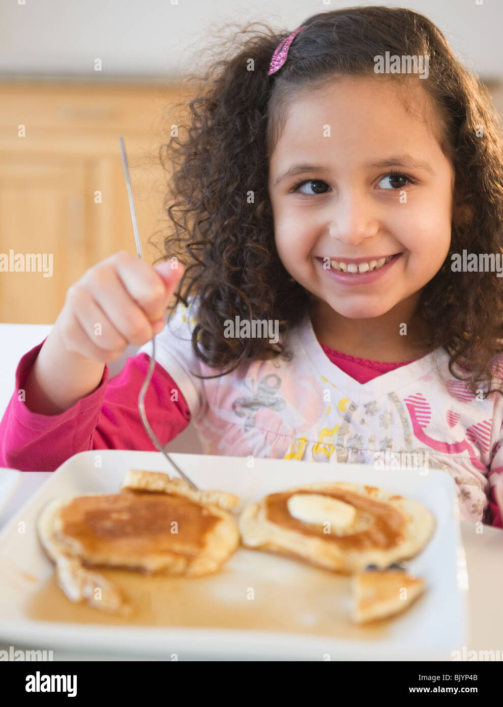 Hispanic girl eating pancakes Stock Photo Alamy