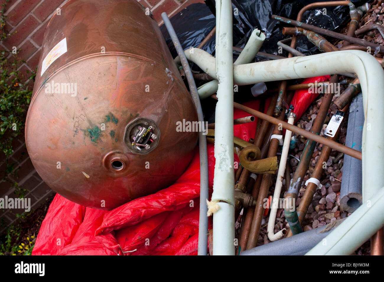 Scrap pipes and hot water cylinder from central heating boiler scrappage Stock Photo