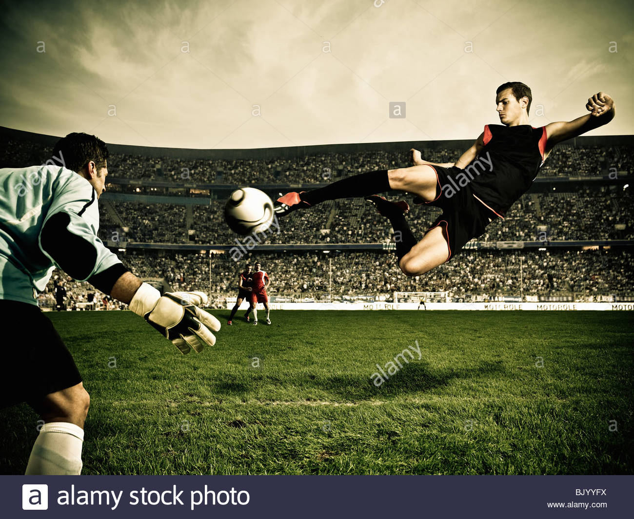 Football Player Kicking Ball Stock Photos & Football Player Kicking