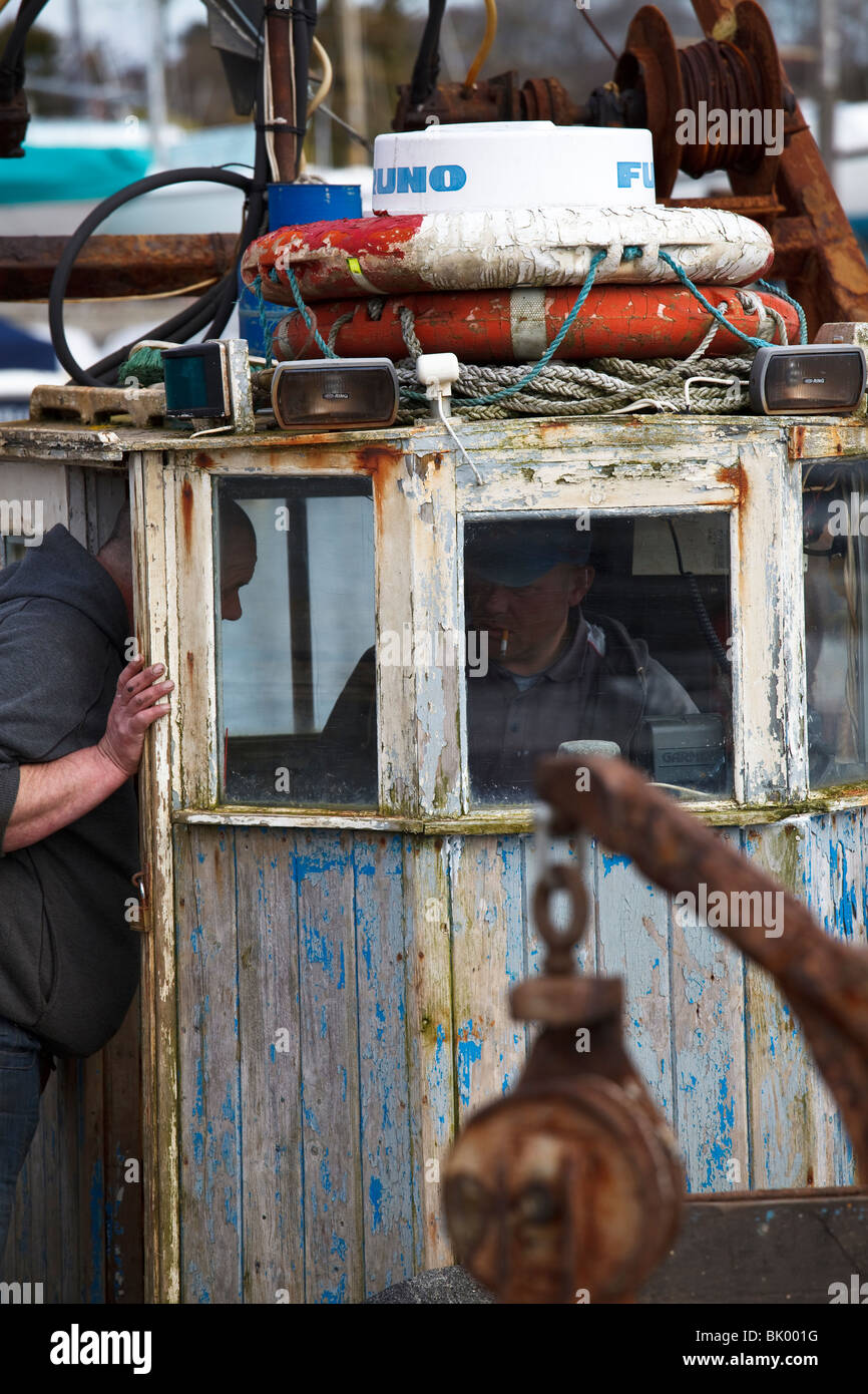 fisherman preparing a stern-trawler / shellfish dredger for inshore/coastal work Stock Photo