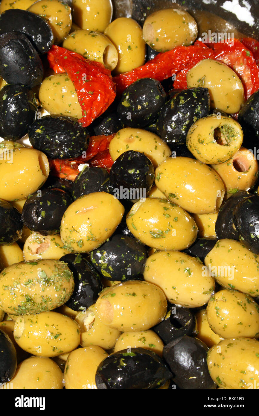 Mixed Olives Black and Green with sun dried tomatoes typical of a healthy Mediterranean diet Stock Photo