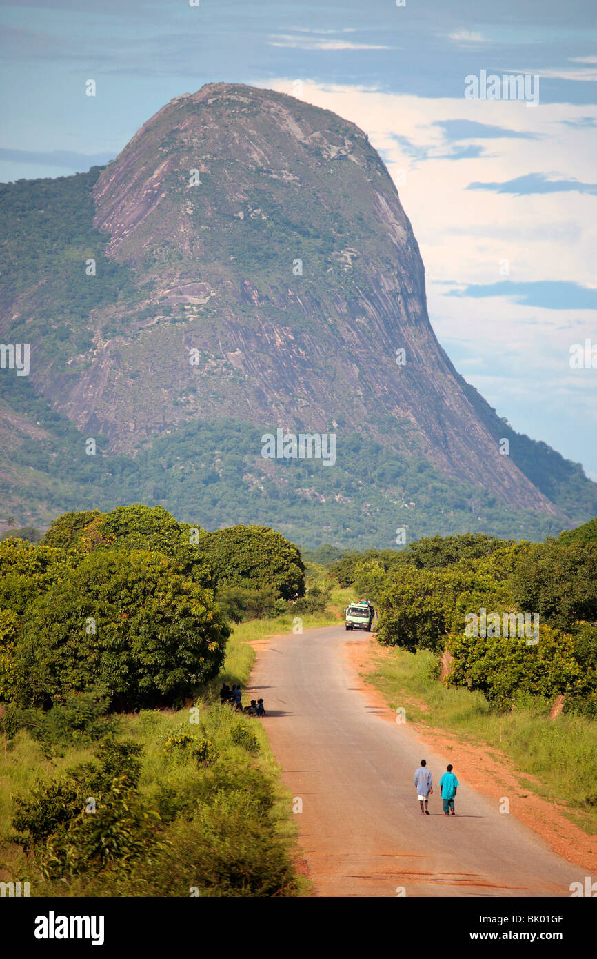 Landscape of Northern Mozambique with inselberg and macadam road Stock Photo