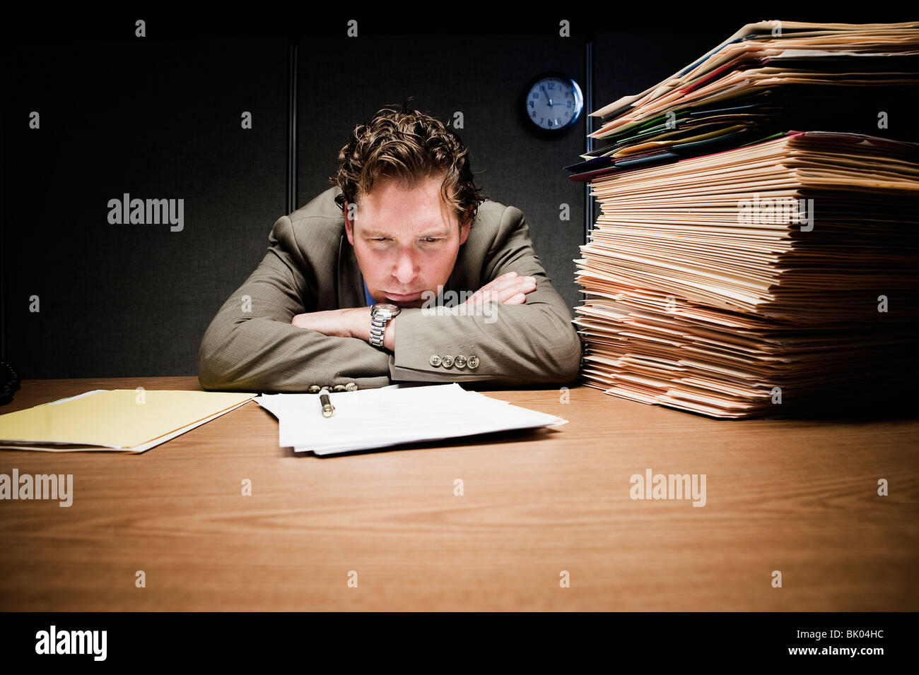 Stressed man with head down on desk Stock Photo Alamy