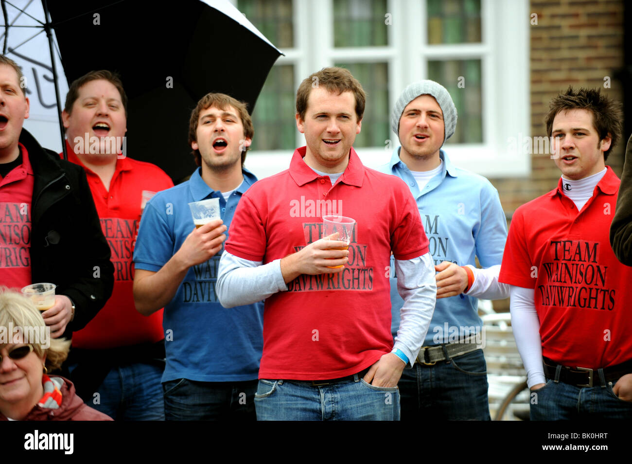 Men enjoy drinking beer at the British and World Marbles Championships held at The Greyhound Pub in Tinsley Green Sussex UK Stock Photo
