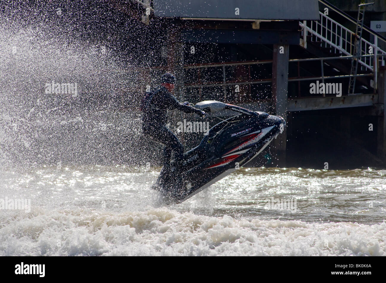 Jet skiing off the beach in Bournemouth, jumping the surf and having fun. Stock Photo