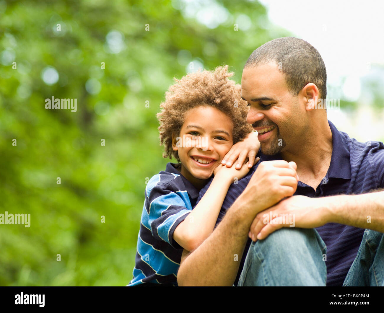 Father and son smiling outdoors Stock Photo