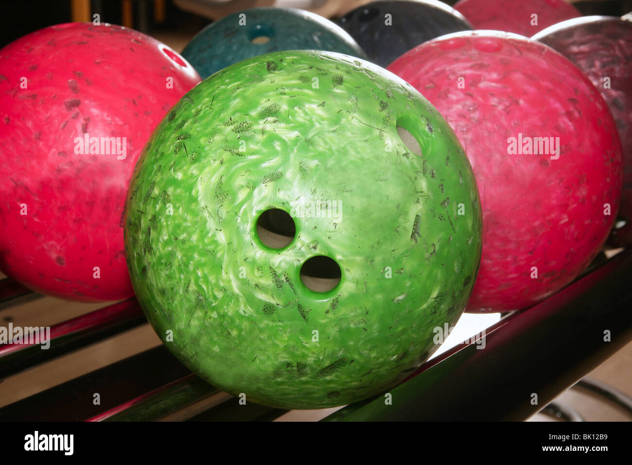 Bowling balls red green closeup row detail Stock Photo - Alamy