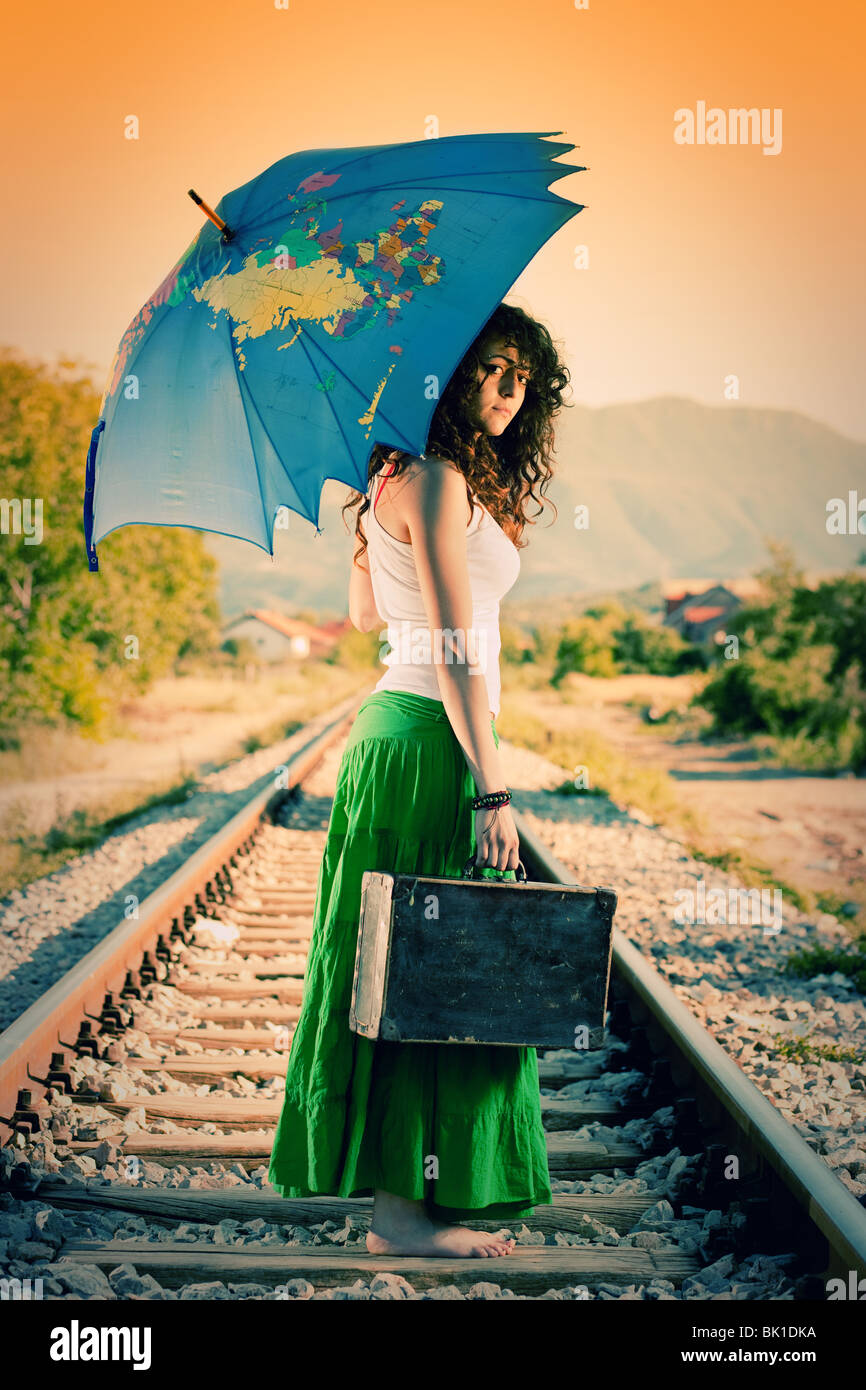 Young girl standing on a railway,running away Stock Photo