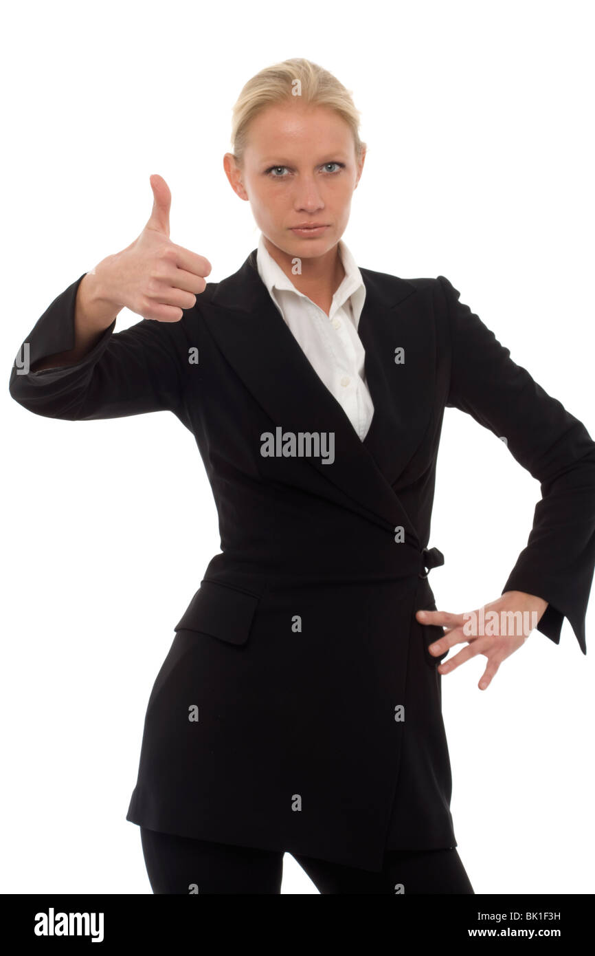 portrait of a young caucasian businesswoman with thumb up and aggressive air wearing a jacket and trousers Stock Photo