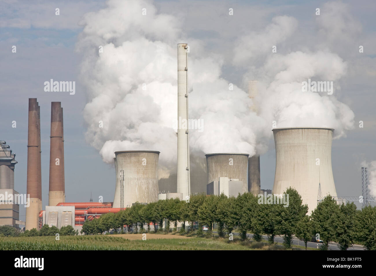 Smoking power plant with trees Stock Photo