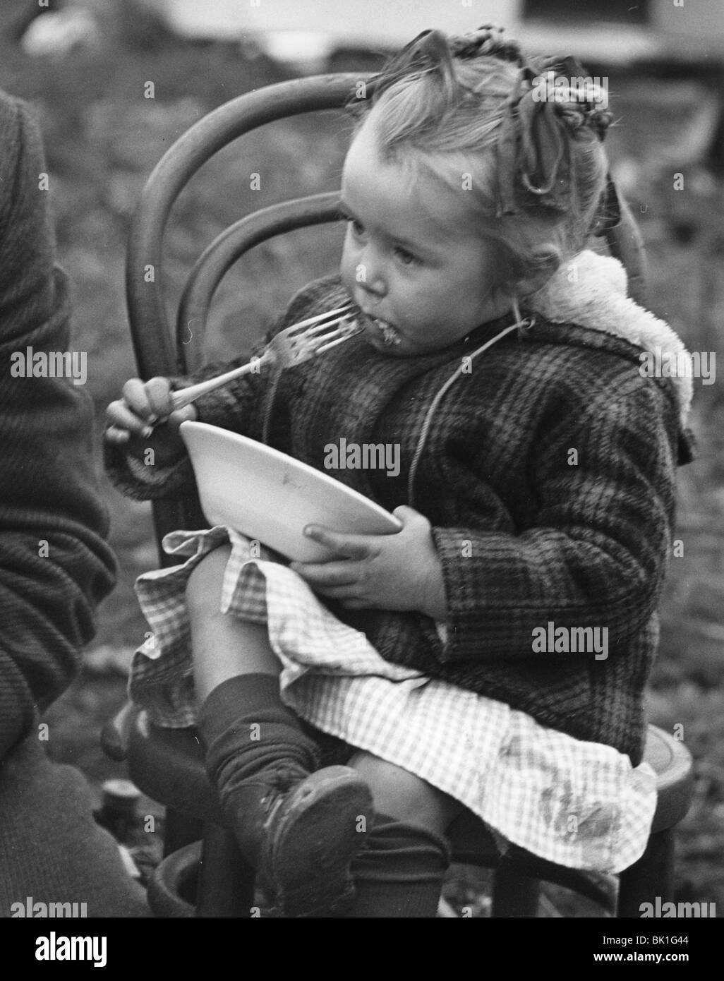 Gypsy girl eating, 1960s. Stock Photo
