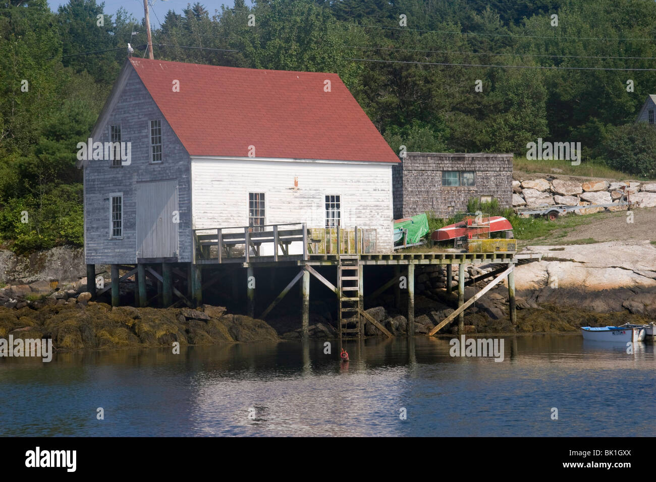 A lobsterman's storage building and pier in Cozy Harbor, Maine Stock