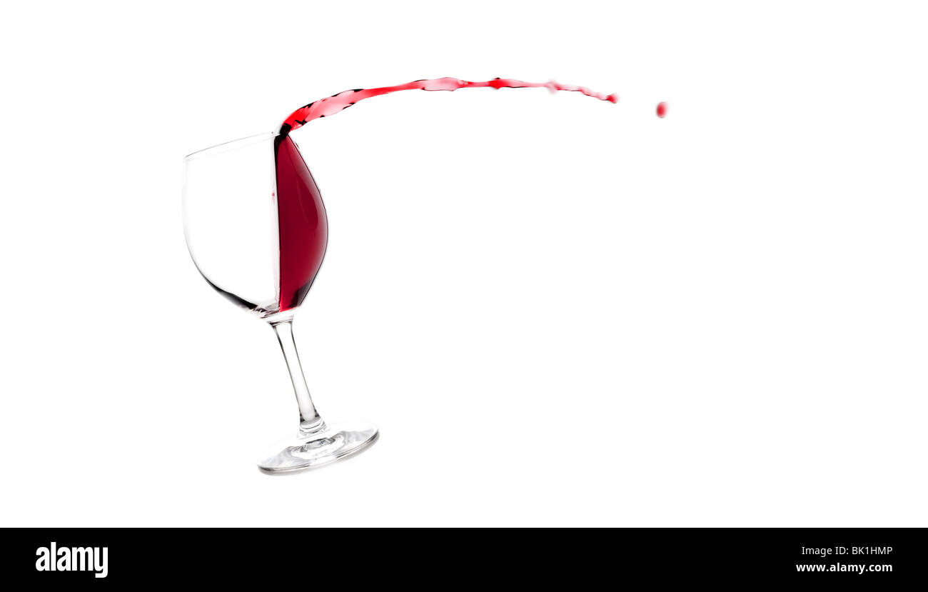 Red wine escaping the wine glass Stock Photo