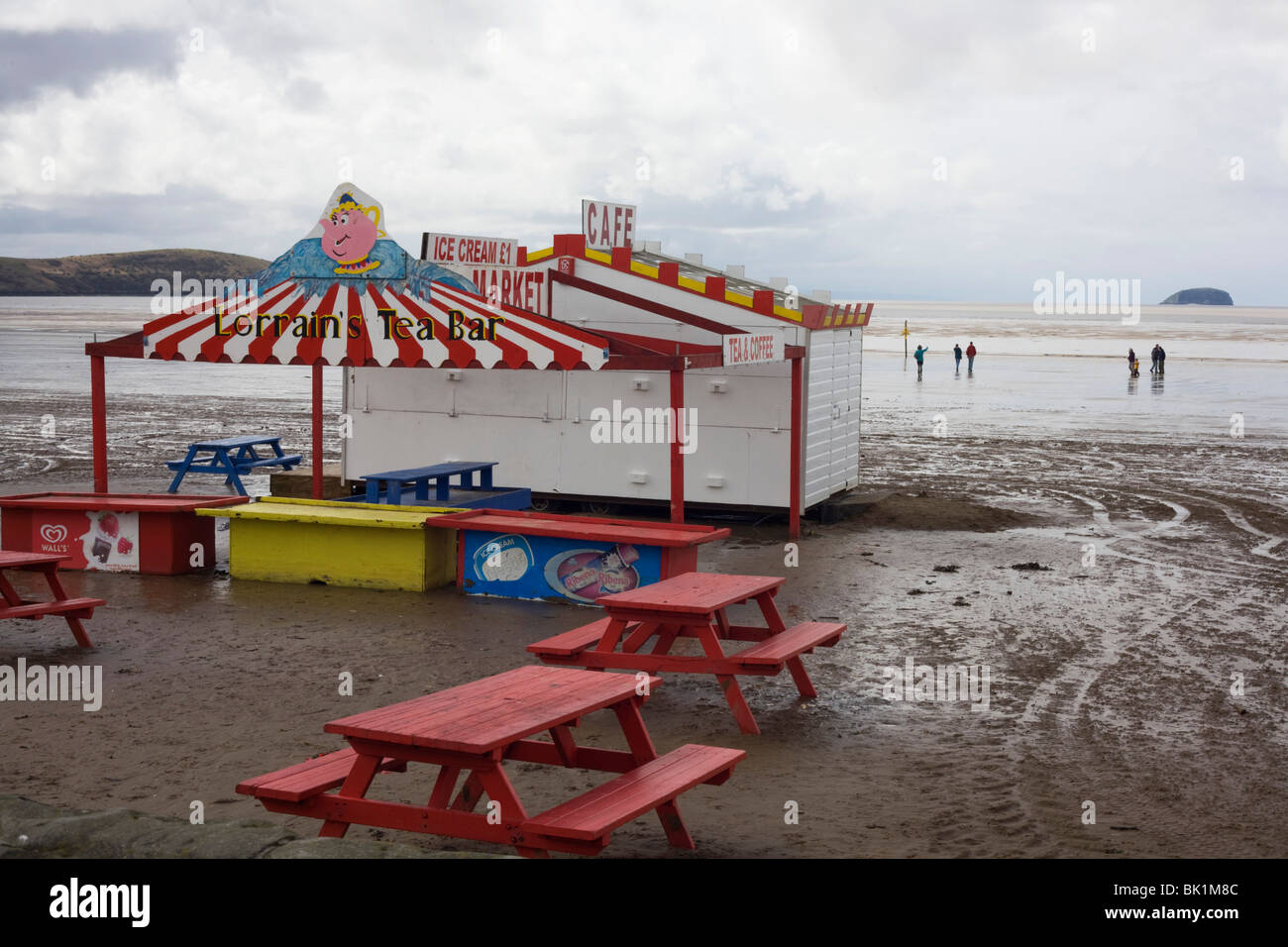 Dull seaside landscape showing empty kiosk picnic benches at Weston-super-Mare in Somerset. Stock Photo